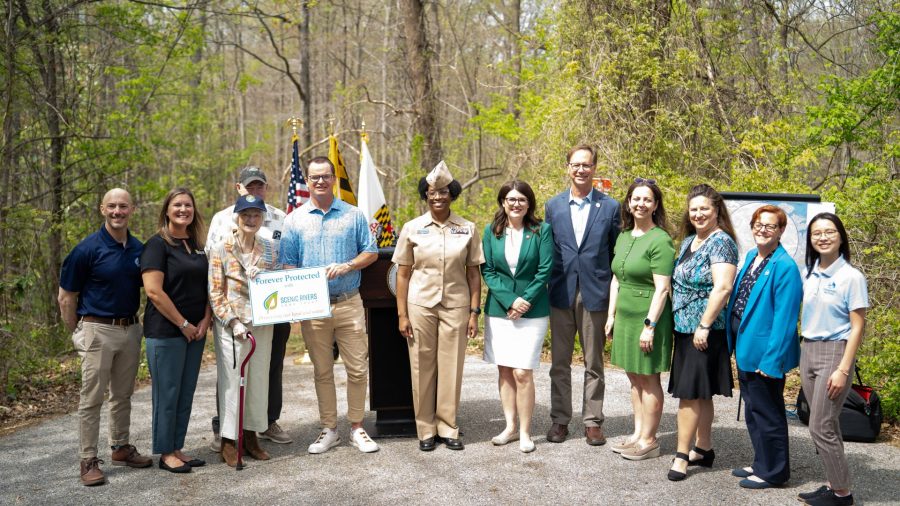 Group of Saltworks Partners gathered for a press photo in front of a forest.